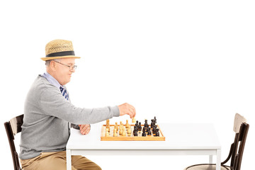 Canvas Print - Senile old man playing a game of chess alone