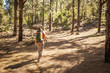 © Tommaso Lizzul - young woman hiking in a pine wood