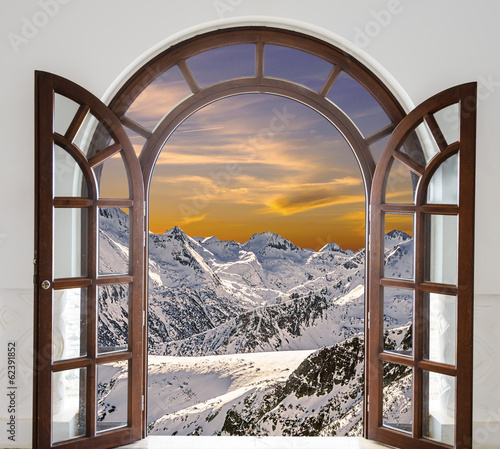 Nowoczesny obraz na płótnie Arch door opened with views of the peaks of snowy mountains and