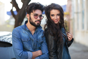 young man stands by smiling woman