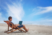 Businessman Working With Computer On The Beach