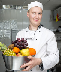 Wall Mural - chef preparing food in the kitchen at the restaurant