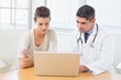 © WavebreakmediaMicro - Doctor and patient using laptop in medical office