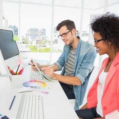 Wall Mural - Casual young couple working on computer in office