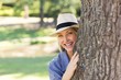 © WavebreakmediaMicro - Woman hiding behind tree trunk