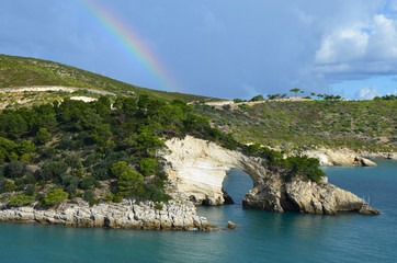 Rainbow over the rock window near Vieste