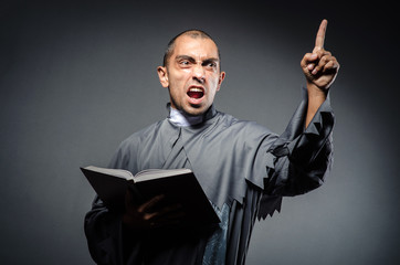 Young priest isolated on the white