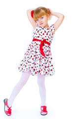 Charming little girl standing leg thrust forward and have fun lo