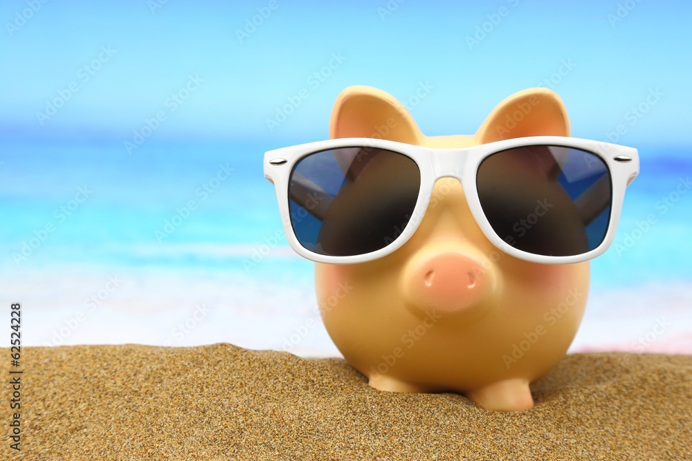 Summer piggy bank with sunglasses on the beach Stock Photo | Adobe Stock
