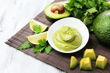 Wall Mural - Fresh guacamole in bowl on wooden table