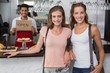 © lightwavemedia - Female friends with male barista at counter in coffee shop