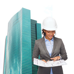 Wall Mural - businesswoman in white helmet with blueprint