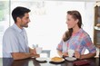 © lightwavemedia - Smiling couple with coffee and croissant at coffee shop