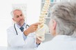 © WavebreakmediaMicro - Male doctor explaining the spine to senior patient