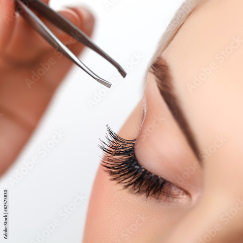 Obraz na plátně Woman eye with long eyelashes. Eyelash extension. Eyebrow