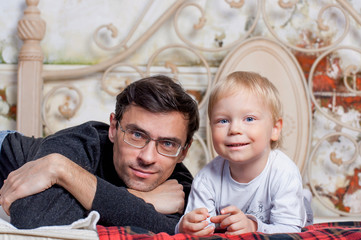 portrait of a father with his to kid at home