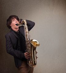 Young musician playing on saxophone