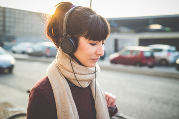 Wall Mural - young beautiful hipster woman listening music