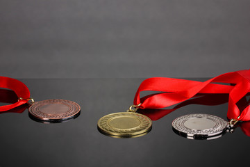 Three medals on grey background