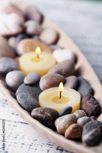 Tapeta ścienna Kamienie spa i świeca w ozdobnej misce,