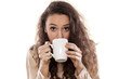 © vladimirfloyd - young girl drinking from a mug on white background