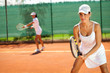 women playing doubles at tennis