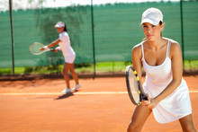 Women Playing Doubles At Tennis
