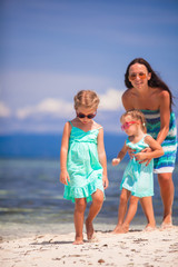 Wall Mural - Young mother and two her daughters have fun at exotic beach on