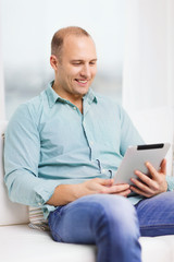 Canvas Print - smiling man working with tablet pc at home