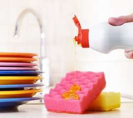 Several plates and a kitchen sponge. Dishwashing concept