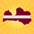 Latvia map flag on sunburst illustration