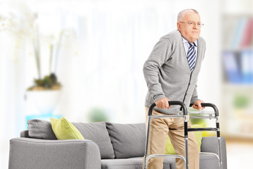 Canvas Print - Senior gentleman walking with walker