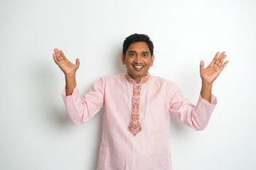 young indian male in traditional cloths celebrating bhangra