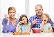 © Syda Productions - happy family with two kids eating at home