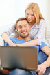 © Syda Productions - smiling happy couple with laptop at home
