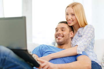 Canvas Print - smiling happy couple with laptop at home