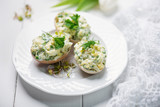 Fototapeta Tulipany - stuffed eggs with fresh herbs and mayonnaise