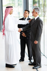 Wall Mural - arabian businessman greeting business partners