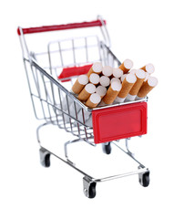 Cigarettes in shopping cart isolated on white