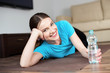 © baranq - Happy young woman lying on the floor after yoga exercises