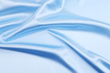 Close up of blue silk fabric background.
