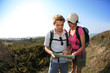 © goodluz - Hikers in country path looking at map