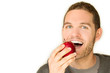Young man eating an apple