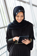 Wall Mural - middle eastern woman using tablet computer