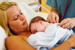 © Trish23 - Nurse listening to baby's chest