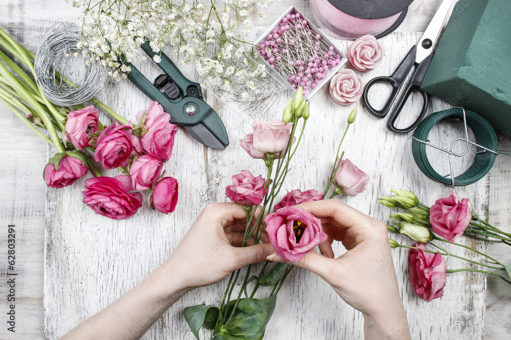 Florist at work. Woman making beautiful bouquet of pink eustoma - obrazy, fototapety, plakaty 