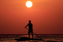 Paddleboarder At Sunset