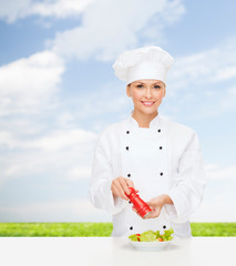 Canvas Print - smiling female chef with preparing salad