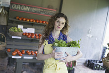 An Organic Farm Stand. A Woman Sorting Vegetables.