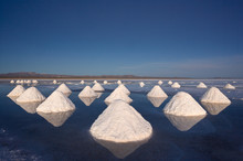 Piles Of Salt Dry In The Arid Atmosphere Of Bolivia's Salar De Uyuni.